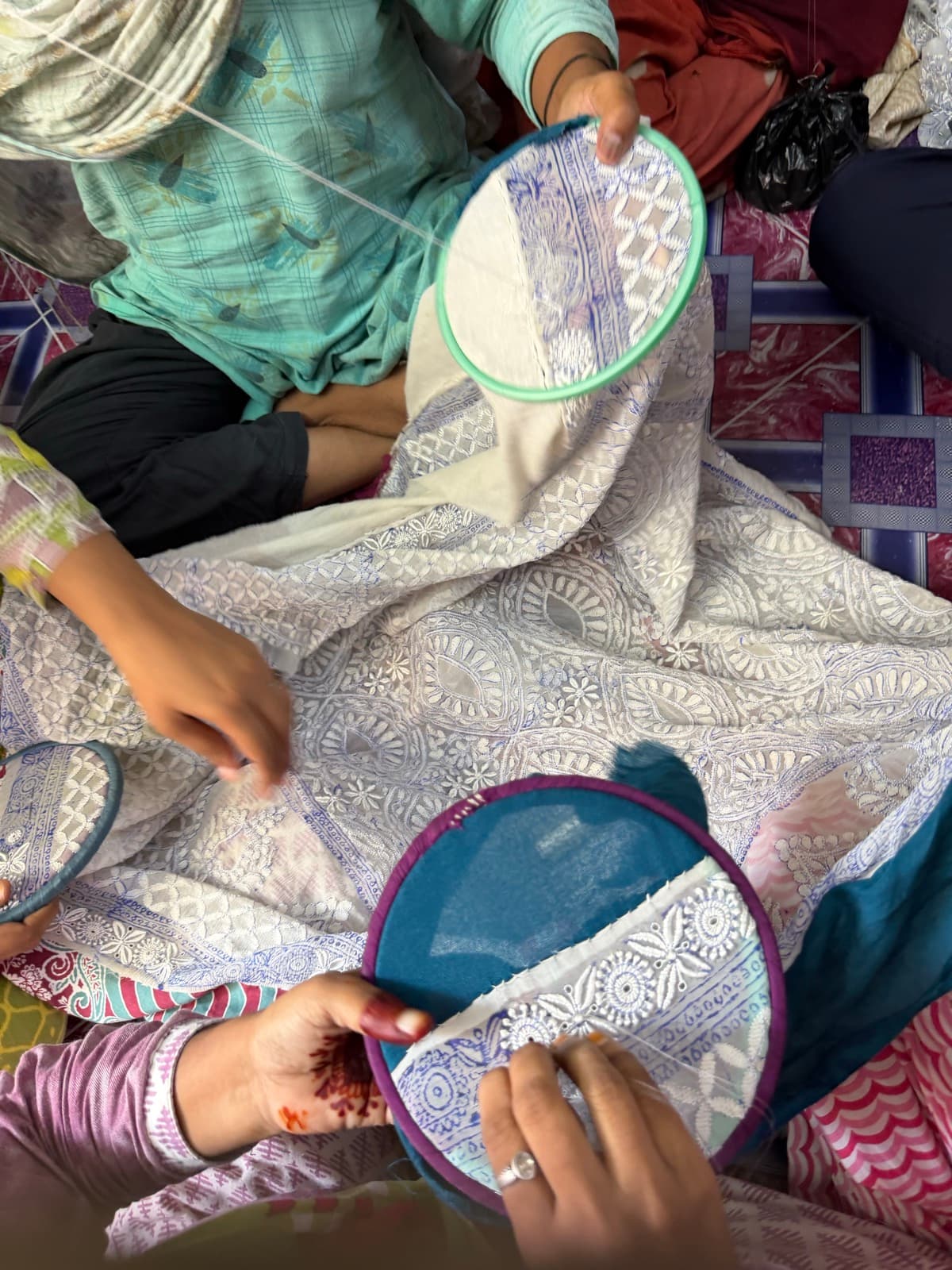 Women artisans embroidering together in the Lucknow workshop