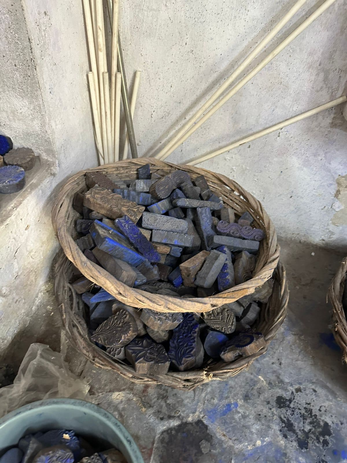 Hand-carved indigo printing blocks in a woven basket